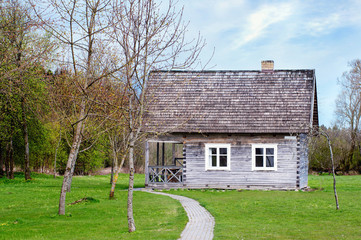 Fototapeta na wymiar Old wooden house with white windows