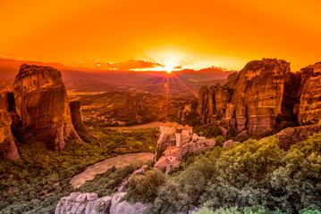 Spectacular colorful sunset over the valley of Meteora, from the best view point, a rock called Psaropetra, Kalambaka, Meteora, Central Greece.