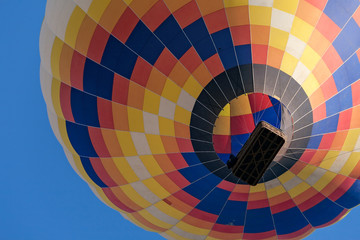 Fototapeta premium Closeup of a colorful hot-air balloon in flight seen from below