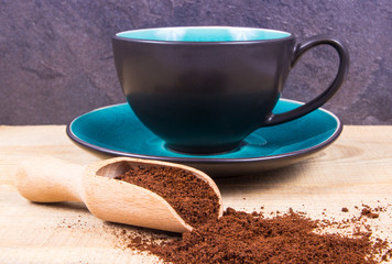 Ground coffee on the wooden background.