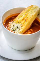 italian minestrone soup with garlic bread and grated cheddar cheese