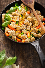 Vegetarian meat free chicken flavoured pieces (mycoprotein) with vegetables on iron cast 
