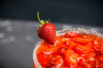 Cocktail strawberry margarita on the wooden background. Selective focus.
