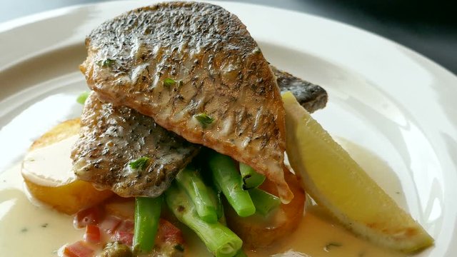 Fish steak with lemon and caper sauce
