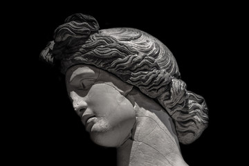 Ancient statue of beautiful woman at black background