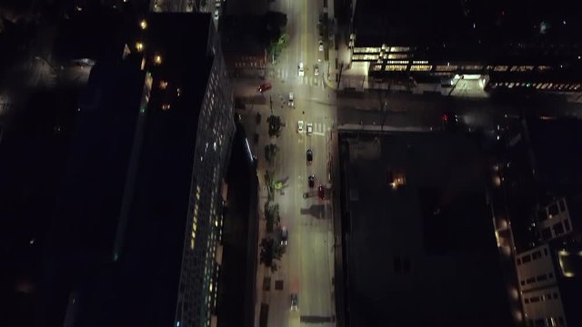 Epic City Aerial at Night Panning Lit Street to Skyline Skyscraper Building Lights