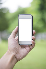 Close up man hand using smartphone in green park, Mockup of blank screen of smartphone
