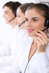 Call center. Focus on beautiful woman in headset