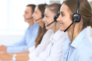 Call center operator in headset while consulting client. Telemarketing or phone sales. Customer...