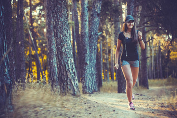 nice young girl on morning jog in a summer forest
