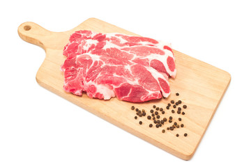 Pork neck chop meat on cutting board isolated on white