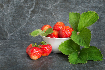 Juicy red strawberries and green leaflets