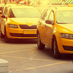 Yellow taxis in the city, sunset and flare, selective focus