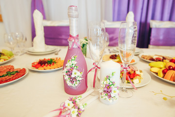 Wedding table with wedding accessories decoration. candles, flowers, champagne.