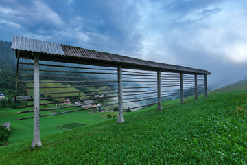 Naklejka premium Hayrack on meadow in Slovenia mountains