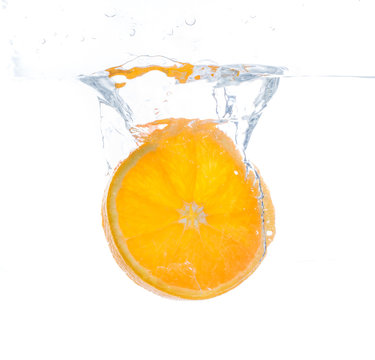orange slice in water splash. white background © eplisterra