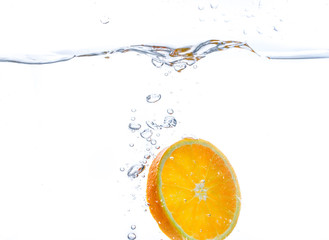 Fototapeta na wymiar orange slice in water splash. white background
