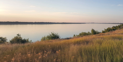 Fototapeta na wymiar shore of the Volga river at sunrise in the sun