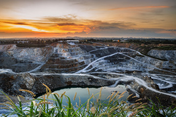 opencast mining quarry with beautiful sunlight and cloudy sky 