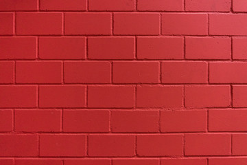 Fototapeta na wymiar Intensive red painted brick wall for background