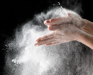 Flour hands on a black background