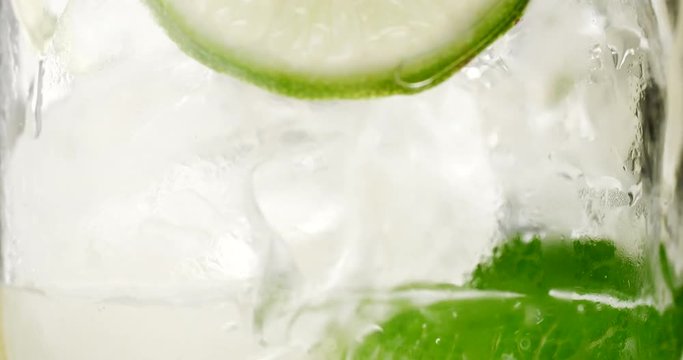 closeup of coctail. Mojito, tonik water with mint and lemon and lime and ice cubes