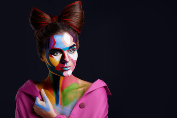 Model with a creative pop art makeup on her face.