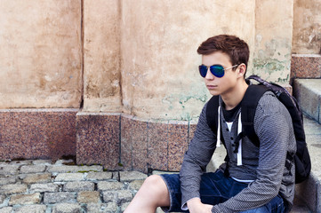 Stylish teenager resting on the stairs steps