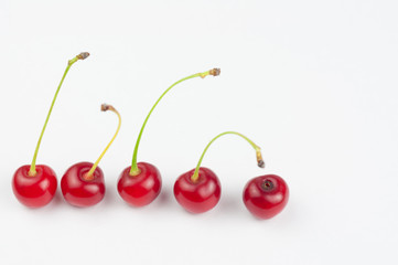 Obraz na płótnie Canvas Red fresh cherries on white background