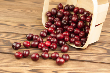Red fresh cherries in bascet on old wooden background