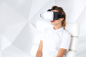 Happy woman getting experience using VR headset glasses of virtual reality at home much gesticulating hands.