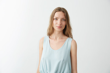 Fototapeta premium Portrait of young beautiful pretty girl smiling looking at camera over white background.