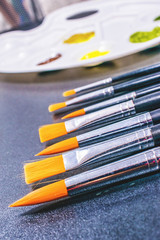 Fototapeta premium Close up of paint brushes and art palette. art and painting background