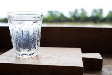 Glass of water on wood