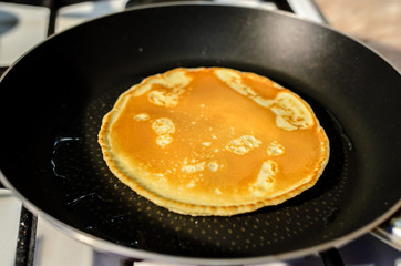 Cooking pancakes in a frying pan.