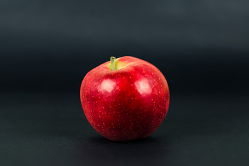 Red apple isolated on dark black background