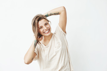 Fototapeta na wymiar Portrait of young beautiful tattooed girl smiling posing looking at camera over white background.