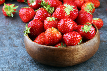 Fresh red strawberry loosely laid in different positions.
