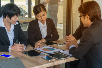 Asian Business people are meeting in a coffee shop.