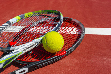 Tennis balls and racket on the grass court