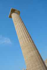 One of the pillars against the blue sky of the Doric temple of Athena Lindia on the Acropolis of Lindos. n the Acropolis of Lindos. Dodecanese Islands, Greek Islands, Greece, Europe