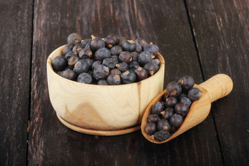 juniper berries on wooden background
