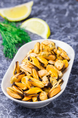 Seafood in a white plate on marble background.
