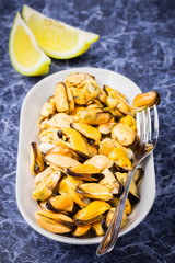  Delicious seafood in a plate on blue marble background.