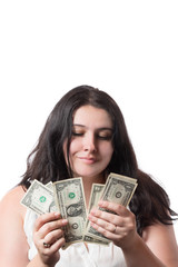 Young brunette woman holding and counting american dollar banknotes money isolated on white