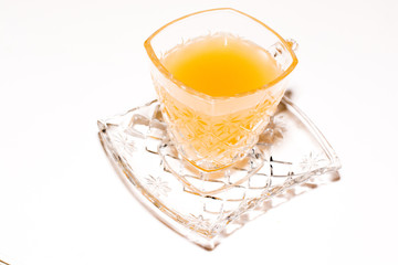 .One glass of ginger juice placed on a white background.