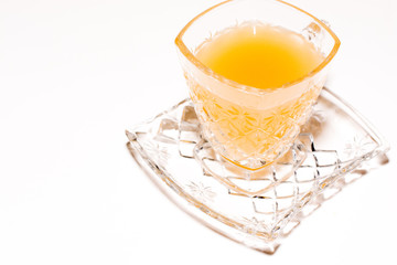 .One glass of ginger juice placed on a white background.