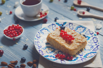 Pastry pie, tea, coffee and berries at blue rustic wood