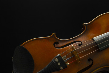 Old violin on a black background