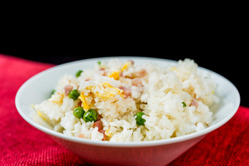 Homemade Chinese fried rice with vegetables and fried eggs